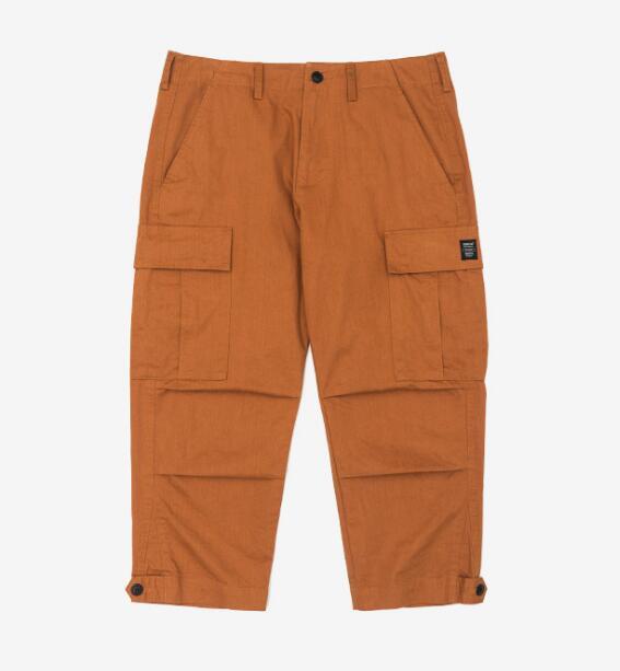 mens wearing camouflage jogger pants with elastic waist and side buttons, styled for a casual streetwear look.
