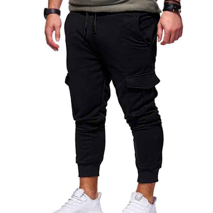 men sport sweatpants jogger pants with elastic waist and side buttons, styled for a casual streetwear look.
